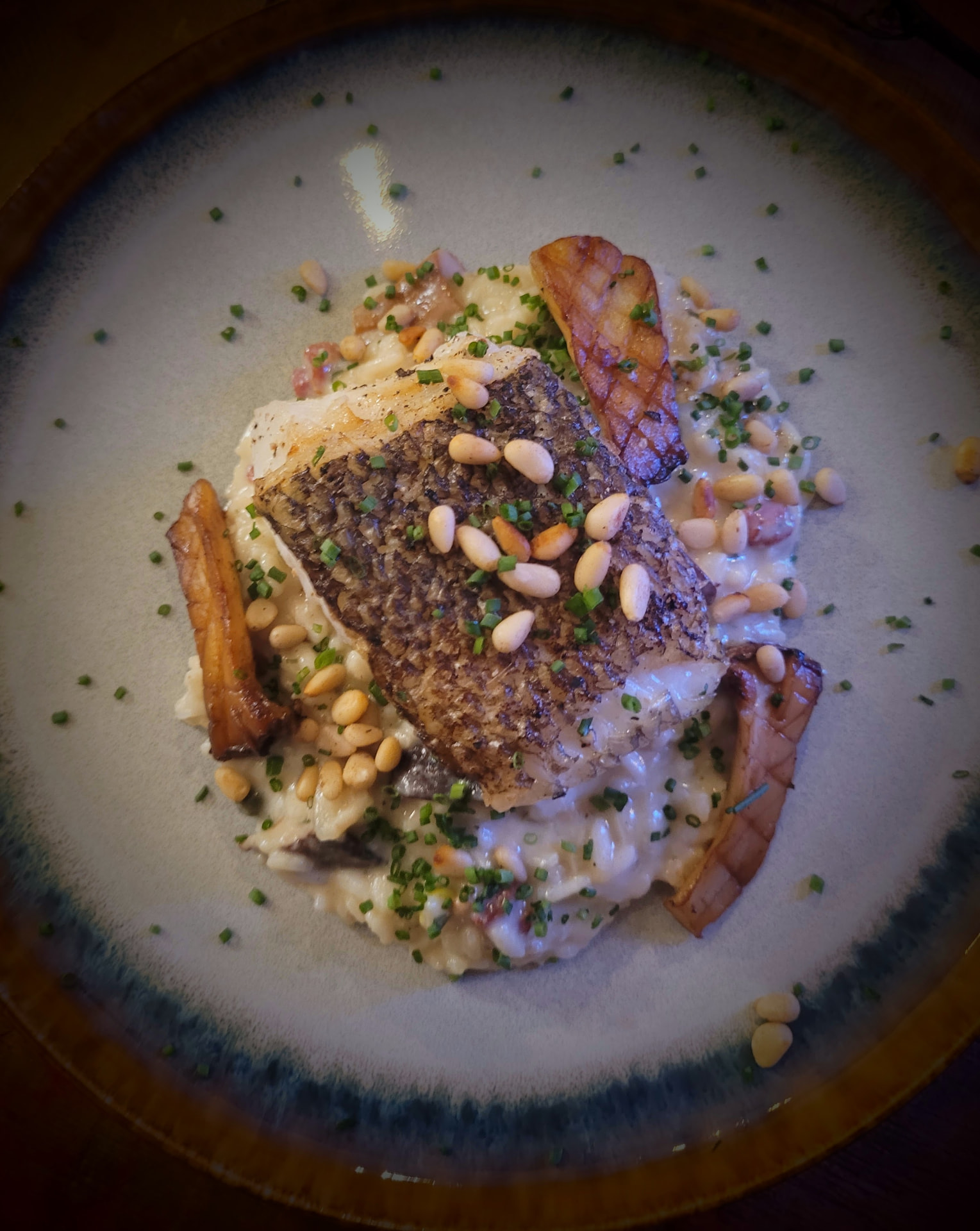 Crisp-skinned cod with pine nuts and roasted roots