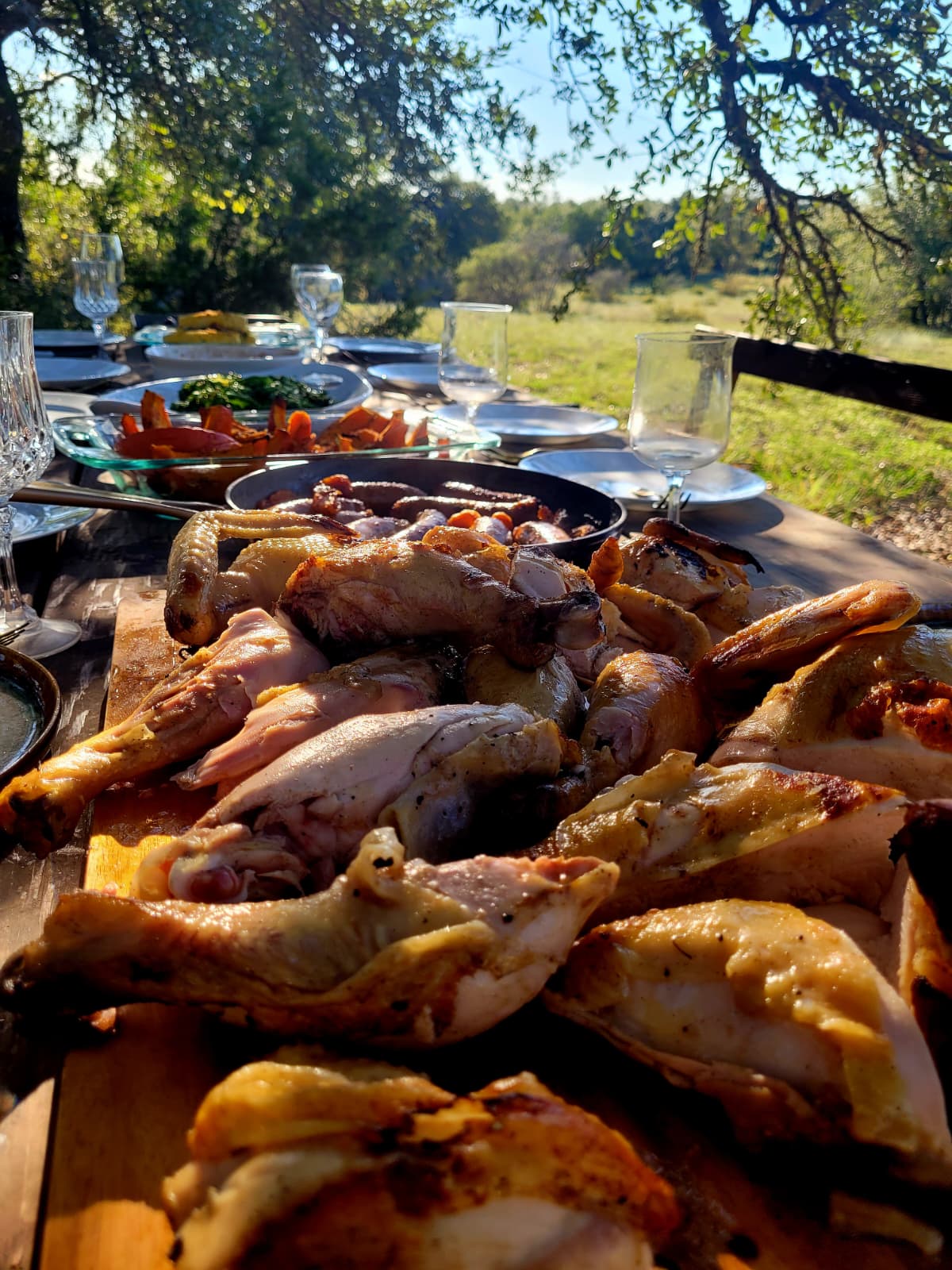 Carved roast chicken piled on the board, ready to share