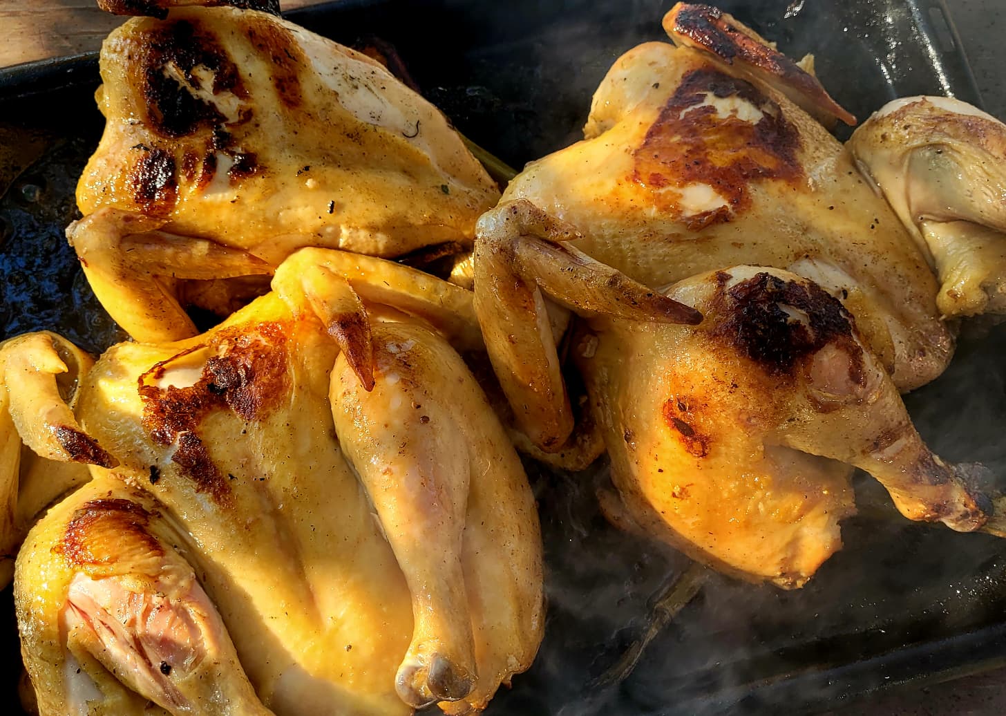 Golden roast chickens fresh from the fire